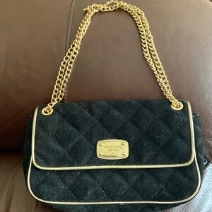 Michael Kors black quilted handbag. Suede material with gold chain.